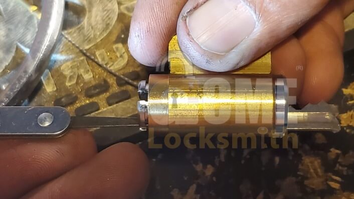 Pushing a broken key out through the back of the lock cylinder.