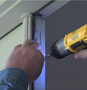 Using a screw to lock the flush bolt.