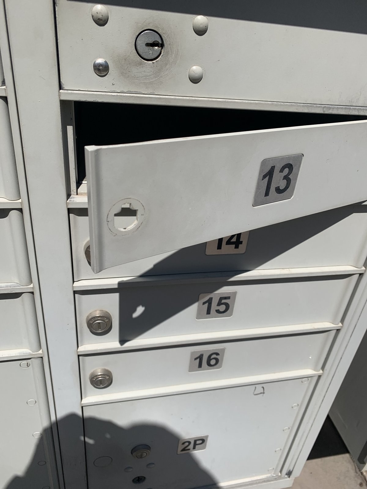 Cluster mailbox resident door open with the old cam lock removed
