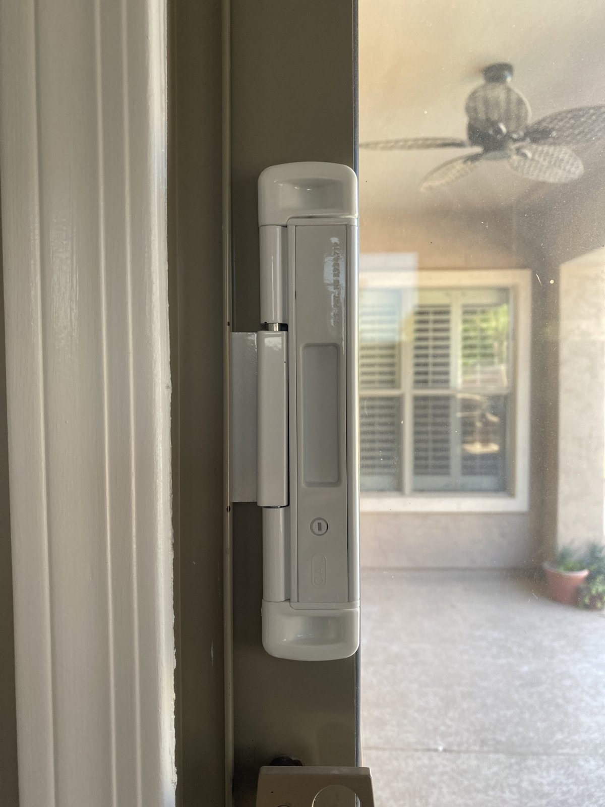 CAL double bolt lock installed on a sliding glass door frame