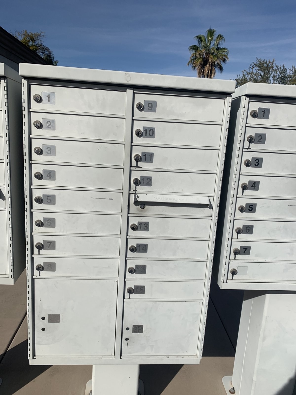 USPS cluster box unit with sixteen resident compartments and an outgoing mail slot